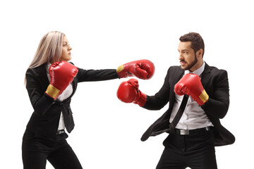 Young businesswoman hitting a businessman with boxing gloves