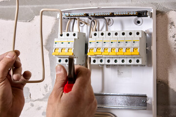 Repair of home wiring, electrical work on installation of switchboard of consumer unit.