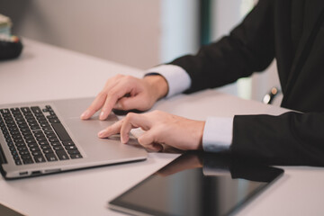 The Communication technology on laptop computer and tablet. Business man working and meeting using internet connection at office. Young adult is modern in job by digital system.