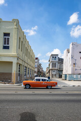 Malecon houses in La Havana with cars driving on the street..American vintage cars colorful in the street of la Havana. Cuban turistic and vintage cars