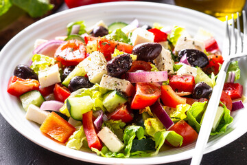 Greek salad. Fresh salad with tomato, cucumber, feta cheese and olives. Close up.