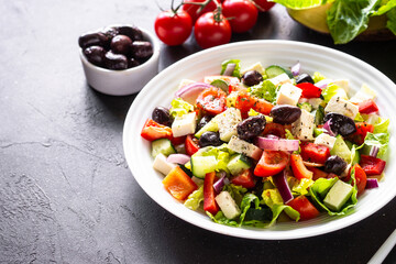 Fototapeta na wymiar Greek salad. Vegetable salad with tomato, cucumber, feta cheese and olive oil.