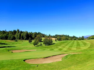 Fotobehang Panoramic view of golf course in Argentine Patagonia under blue sky. Nature and outdoor sports. © Su Nitram