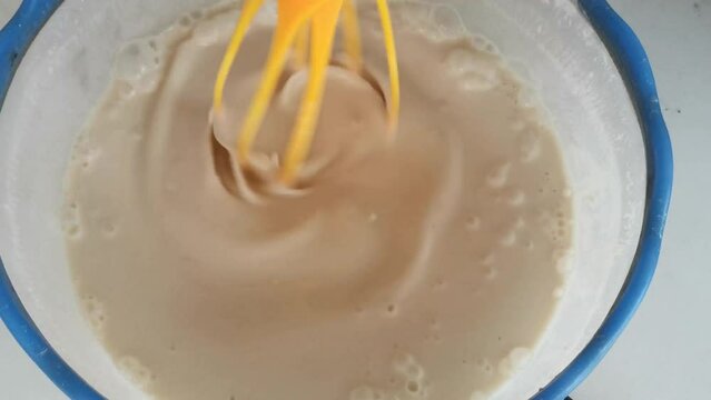 The process of making rice flour with raw materials on the table Beat the eggs and flour with a mixer, part four.