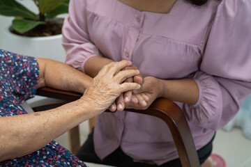 Holding hands Asian senior or elderly old lady woman patient with love, care, encourage and empathy at nursing hospital ward, healthy strong medical concept