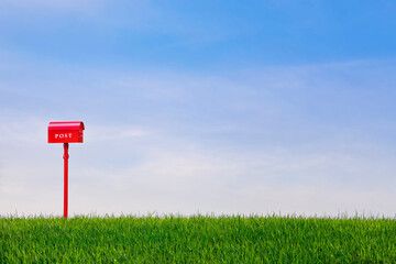 blue hills, sky and red postbox