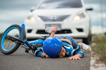 A boy was injured because his bicycle collided with a car on the road. Asian boy was hit by car....
