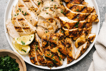 Overhead of two types of sliced grilled chicken breast