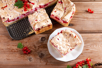 Appetizing homemade berry pie. Pie with red currants and sour cream on wooden table