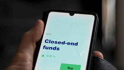 An investor's analyzing the  on screen. A phone shows the ETF's prices closed-end funds