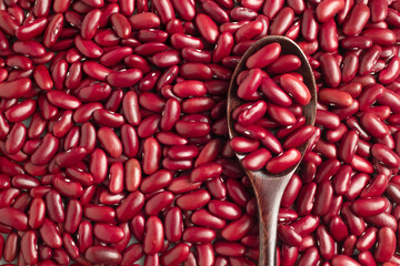 Close-up photo of several red kidney beans  and wooden spoon,top view,flay lay,top-down.