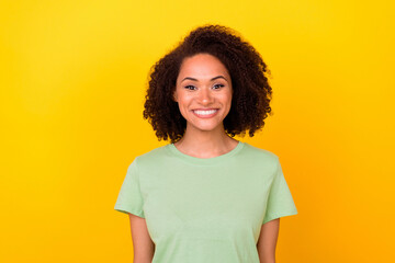 Photo of cute brunette young lady wear green t-shirt isolated on yellow color background