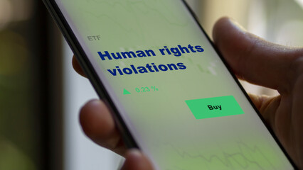 An investor's analyzing the human rights violations etf fund on screen. A phone shows the ESG ETF's prices stocks to invest