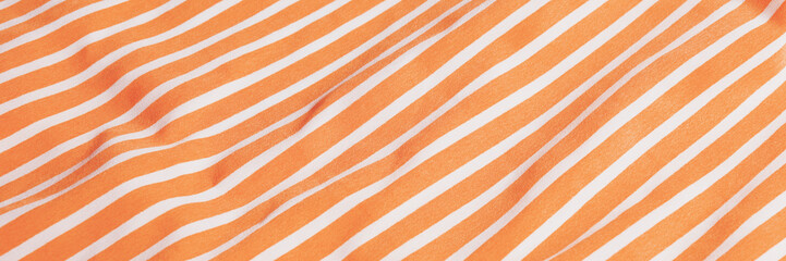Beautiful orange fabric with white stripes background. Draped background of fabric, texture. Abstract background. Banner