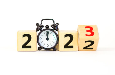 Business concept of 2023 new year symbol. Turned a wooden cube and changed number 2022 to 2023....