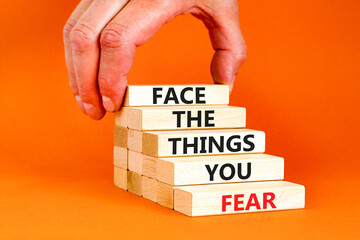 Face the things you fear symbol. Concept words Face the things you fear on wooden blocks on a...