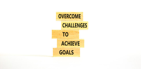 Overcome challenges to achieve goals symbol. Concept words Overcome challenges to achieve goals on wooden blocks on a beautiful white table white background. Business goals concept. Copy space.