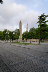 Egyptian obelisk at the hippodrome in Istanbul, with the blue sky with a big cloud in the afternoon.