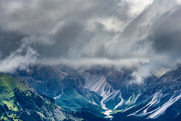 Moody sky over rocky mountains in the Dolomites, Trentino Italy. Summer 2021