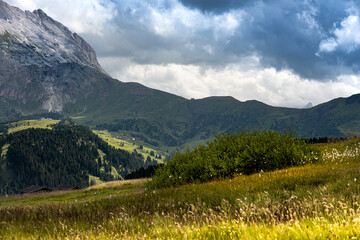 Obraz premium Moody sky over meadows in the Dolomites, Trentino Italy. Summer 2021
