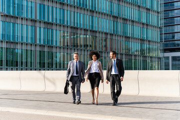 Business people meeting in a business park - International multiethnic business team walking on the street in the city