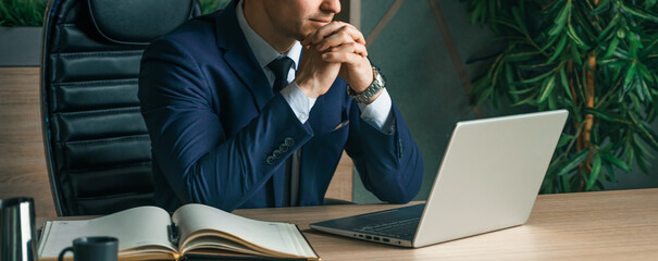 Businessman working with laptop in modern office. General manager,ceo. Young handsome confident man...