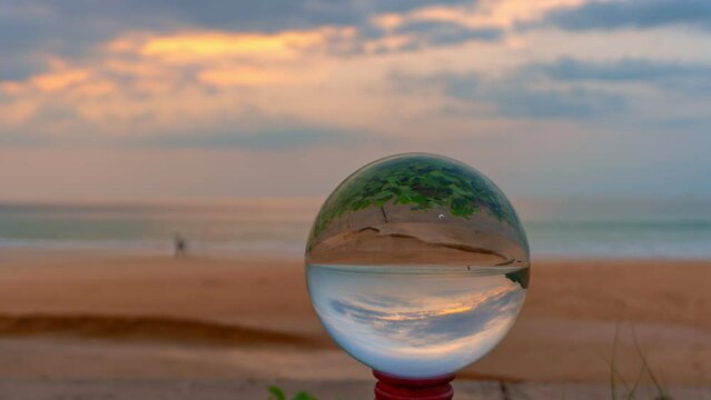 timelapse sunset in crystal ball the image that appears in an upside-down looks strange.
The natural view of the sea and sky in beautiful sunset are unconventional and beautiful inside crystal ball