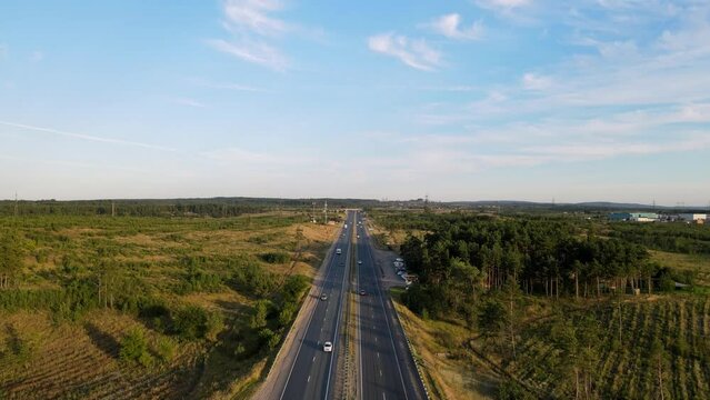 Filming of the road from the air. A road in the middle of a natural landscape, connecting cities and countries with each other. The path that has the final destination