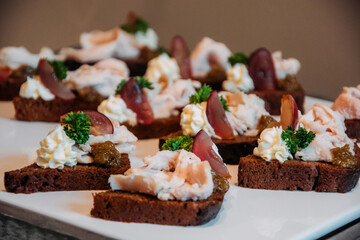 Appetizing sandwiches with meat slices, herbs and white sauce.