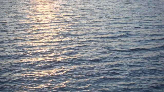 Looped video of calm water and sunlight.