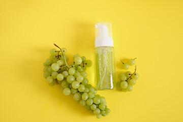 mock up blank white bottle and grapes on yellow background