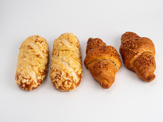 Baked goods croissant and cheese bun on white background.