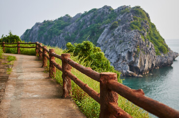 eco-trail fenced with a low wooden fence along the rocky sea coast overlooking the mountain