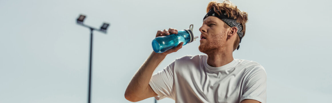 Young Sportsman Drinking Refreshing Water From Sports Bottle Outdoors, Banner