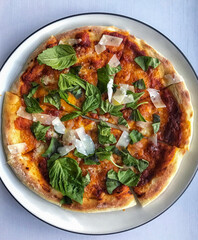 pizza with parmigiano reggiano and basil