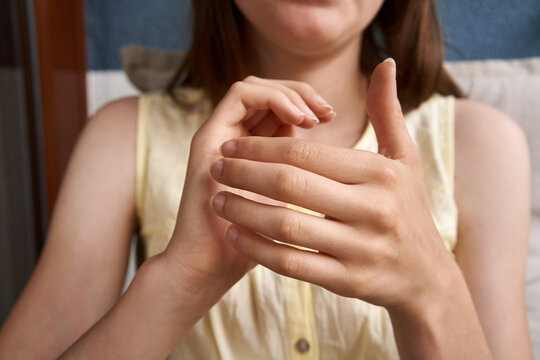 Hands of a teenage girl practicing EFT - emotional freedom technique - tapping on the karate chop point