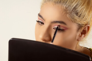 Closeup of woman making a makeup yourself.