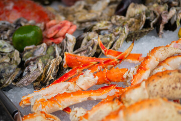 Raw crab claws on counter at summer local fish market - close up. Retail, gastronomy and seafood concept