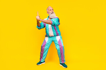 Fototapeta premium Full length portrait of serious aged person hold shoot bat empty space wear condensed milk tin color clothes isolated on yellow background