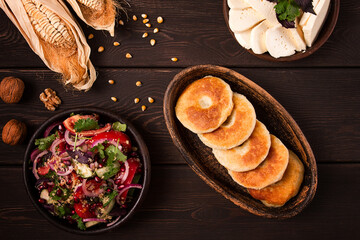 Mchadi, corn tortillas, traditional Georgian dish, corn bread, with Imeretian cheese, homemade, no people, on a wooden table,