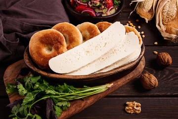 Mchadi, corn tortillas, traditional Georgian dish, corn bread, with Imeretian cheese, homemade, no people, on a wooden table,