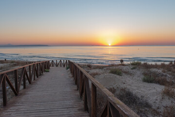 Sunrise on the wooden boardwalks of the beach