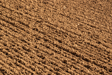 Full-frame image of brown soil on a freshly ploughed field, suitable as an agricultural background...