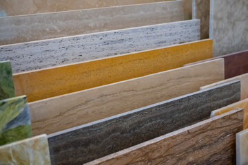 Colorful granite and marble stone slabs on counter for sale at hardware store, market - close up view. Abstract, retail, design, decoration concept