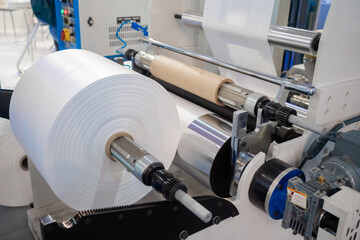 Moving roller with flat transparent polyethylene film at exhibition, trade show - part of automatic...