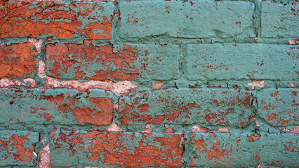 Old vintage red brick and peeled paint wall masonry exterior.