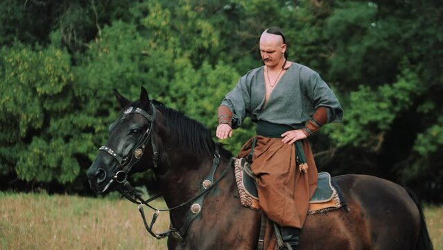 Cossack on horseback. Ukrainian Cossack in the Zaporozhian Sich. Strong people. Patriots of their country. Kievan Rus.