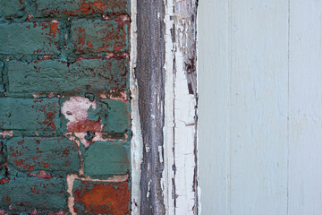 Old vintage red brick and peeled paint wall masonry exterior.