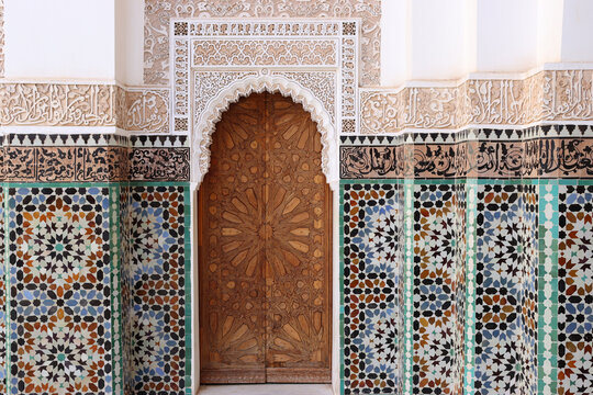 Arabic wooden door with arch and colorful tiles. Typical Moroccan decoration