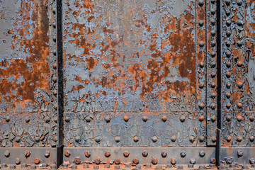 Rusty metal background - Old rundown grey and blue peeling paint reveal patterns on a rusted metal surface.